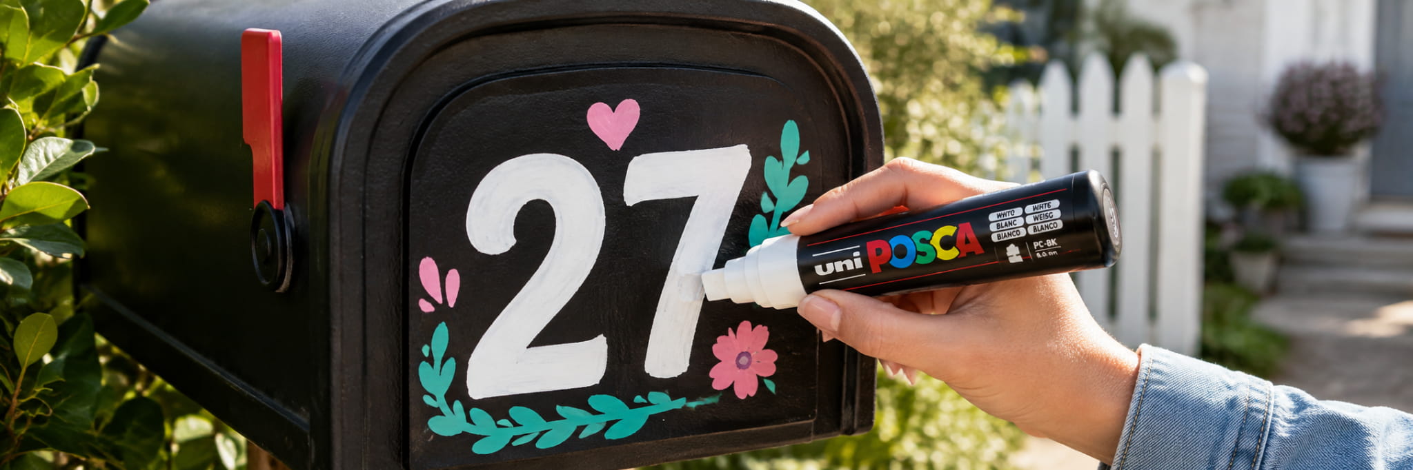 Broad chisel-tip POSCA marker being used on an outdoor letterbox sign