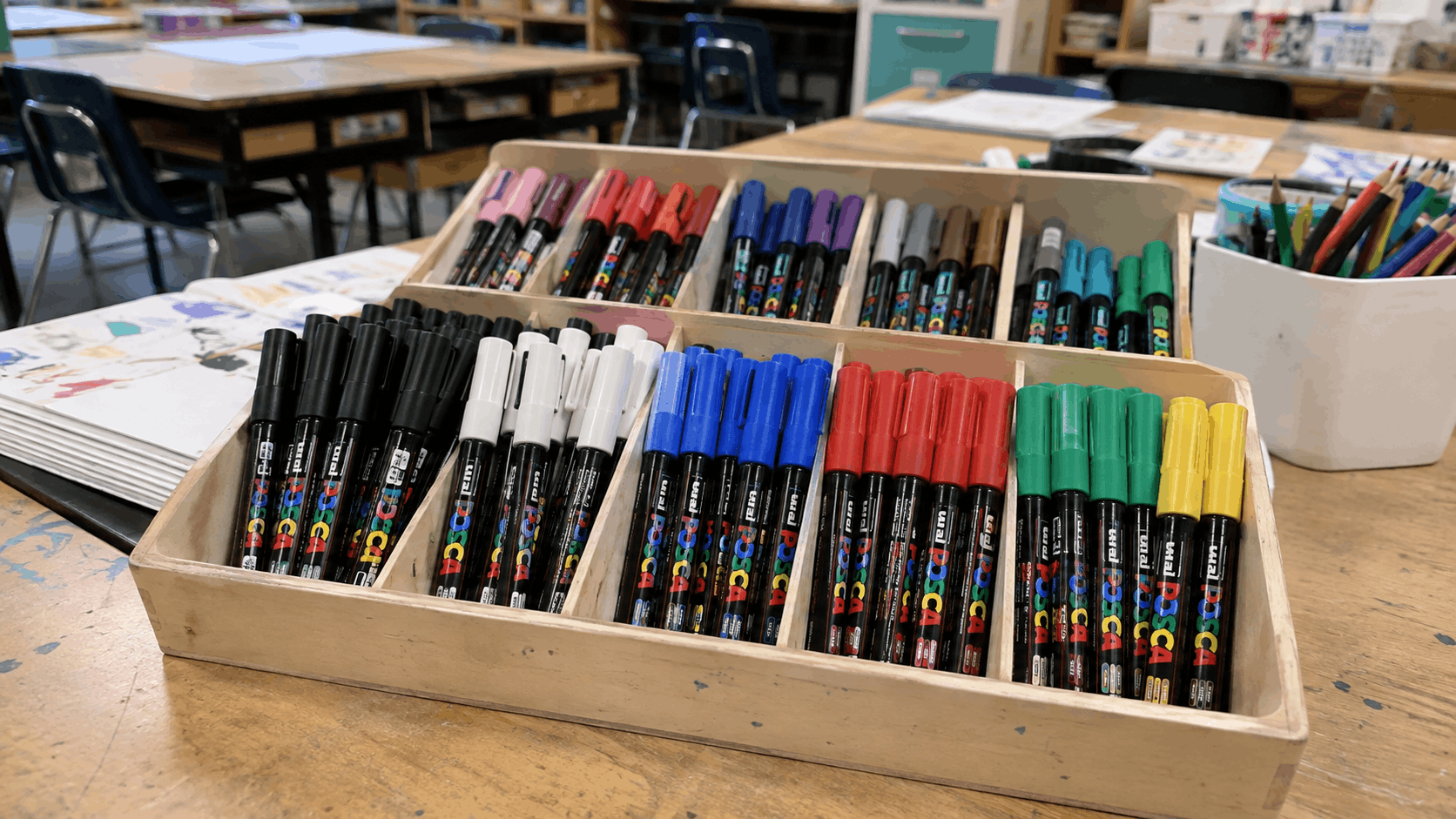 Classroom set of assorted POSCA pens arranged in a supply tray