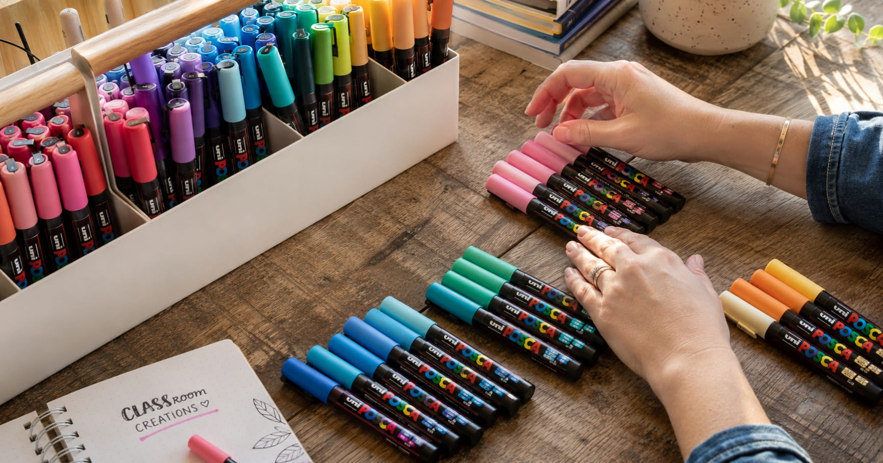 Close-up view of water-based non-toxic Uni POSCA markers being organised by an art teacher